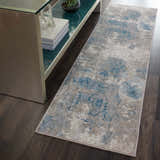 Entryway with Nourison Karma Ivory/Light Blue runner rug, vintage style, on dark wood floor next to console table.