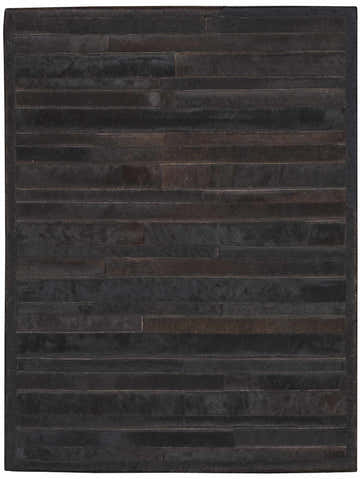 Close-up of the Calvin Klein Home Prairie Black Area Rug, featuring a handmade, horizontal hair-on-hide pattern.