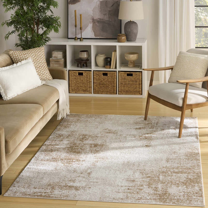 Living room with tan sofa and Nourison Dekor Ivory Beige rug, creating a modern, neutral aesthetic.
