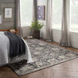 Serene bedroom with a Nourison Oushak Home Charcoal rug, wood floors, soft gray curtains, and natural light.