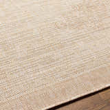 Close-up of the Djugun Beige Indoor & Outdoor Rug. Shows woven texture and subtle geometric pattern in beige and bone. Texture