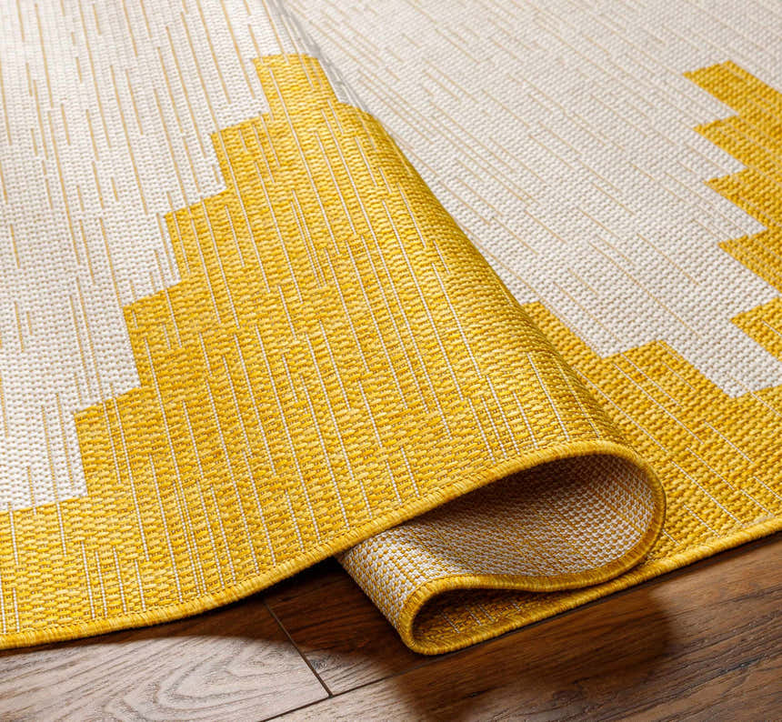 Close-up of Djugun Yellow Outdoor Rug showing geometric pattern, woven texture, and colors of beige, bone, and yellow. Fold
