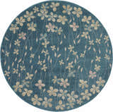 Close-up of round Nourison Tranquil Turquoise rug. Aqua rug with a floral pattern in beige, pink, and blue.