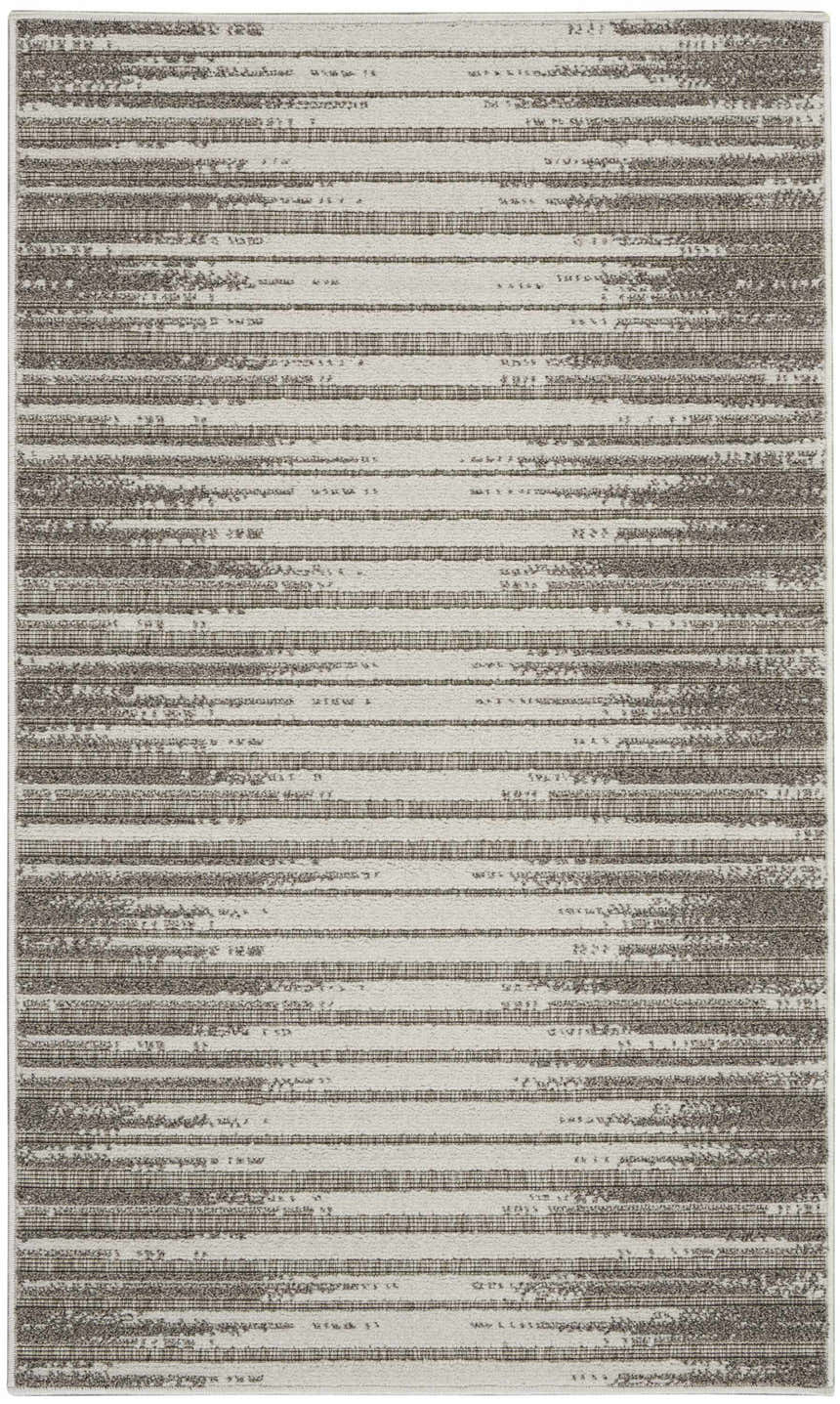 Close-up of Nourison Key Largo Light Grey rug featuring a contemporary striped pattern and subtle texture.
