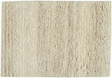 Close-up of the beige, handmade, wool Calvin Klein Agadir shag rug, showing the pile and texture.