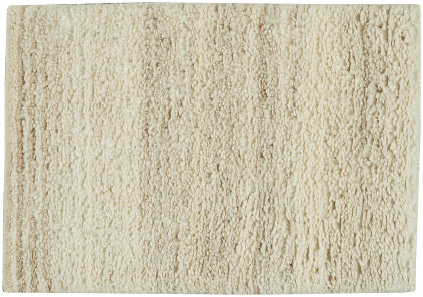 Close-up of the beige, handmade, wool Calvin Klein Agadir shag rug, showing the pile and texture.