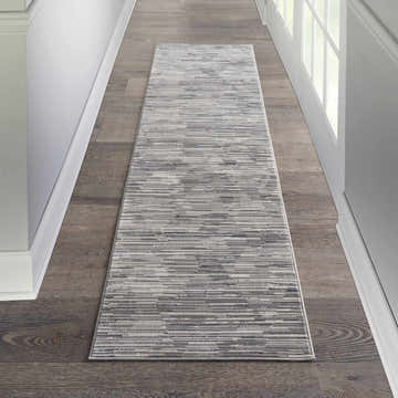 Hallway with Michael Amini MA90 Uptown Grey Ivory rug runner on dark wood floor, white trim. Modern style.