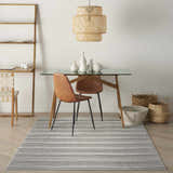 Dining room with glass table and Nourison Key Largo Dark Grey rug. Contemporary style.