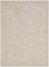 Close-up of the Calvin Klein CK044 Wander Taupe rug. Features a modern, abstract ivory line pattern on a taupe wool blend.