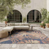 Outdoor patio scene with a sectional sofa and the Nourison Aloha Blue Rose rug.