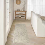 Living room scene with a DKNY Pure Angles Grey rug, white sofa, wood floors, and neutral decor.