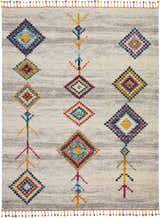 Close-up of Nourison Nomad Cream Grey Tribal rug featuring colorful diamond patterns and playful fringe.