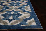 Close-up of the Celestial Waverly Sun N' Shade rug. Features a blue, gray, and white geometric pattern on dark wood floors.