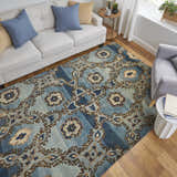 Living room scene with Feizy Amzad blue, gray, and tan wool rug, white sofa, and gray armchair on wood floor. Roomscene-Rectangle