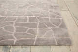 Close up of the gray Nourison Escalade Granite area rug featuring a geometric, cobblestone-like pattern and soft texture.