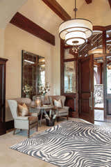 Entryway with wingback chairs and Barclay Butera Madagascar Graphite rug. The rug has a gray and white zebra print.