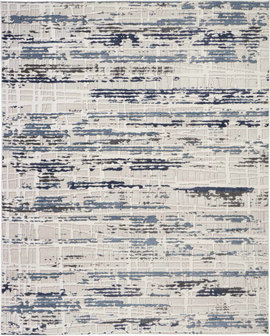 Close-up of Nourison Urban Decor Ivory/Slate rug. Modern design with chestnut, blue, and gray abstract pattern on an ivory base.