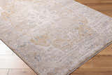 Close-up of Rhody Luxe Rug in light silver and sterling gray with a traditional, subtle pattern on wood flooring. Corner