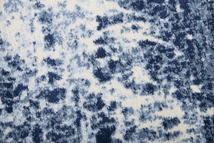 Close-up of the Rizzy EN7262 area rug. Contemporary design in shades of blue, navy, and ivory. Soft, textured polypropylene. Texture