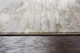 Close up of Rizzy EN7264 area rug showing beige, ivory, light brown, and light gray abstract pattern and soft texture. Pile