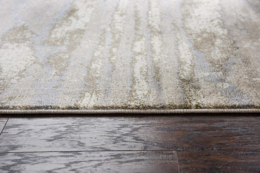 Close up of Rizzy EN7264 area rug showing beige, ivory, light brown, and light gray abstract pattern and soft texture. Pile