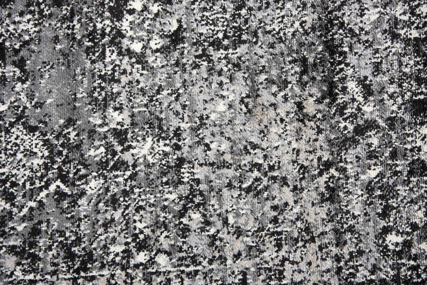 Close-up of Rizzy EN7272 area rug showing its black, ivory, and light gray abstract pattern and soft, textured pile. Texture