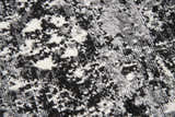 Close-up of Rizzy EN7272 area rug showing black, ivory, and light gray abstract pattern and soft, textured polypropylene fibers. Texture