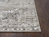 Close-up of Rizzy EN7351 area rug showing traditional farmhouse pattern and texture on dark wood floor. Corner