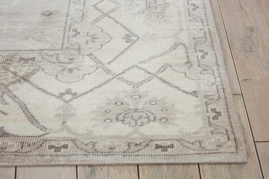 Close-up of the Nourison Aldora Silver Vintage Area Rug showing its gray vintage pattern and soft, silk-like texture.