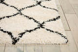 Close up of Nourison Windsor Ivory Shag Rug. Features a chestnut diamond pattern and plush, soft texture.