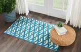 Entryway with Nourison Harper Blue Colorful runner rug, wood floors, wicker ottoman, and natural light.
