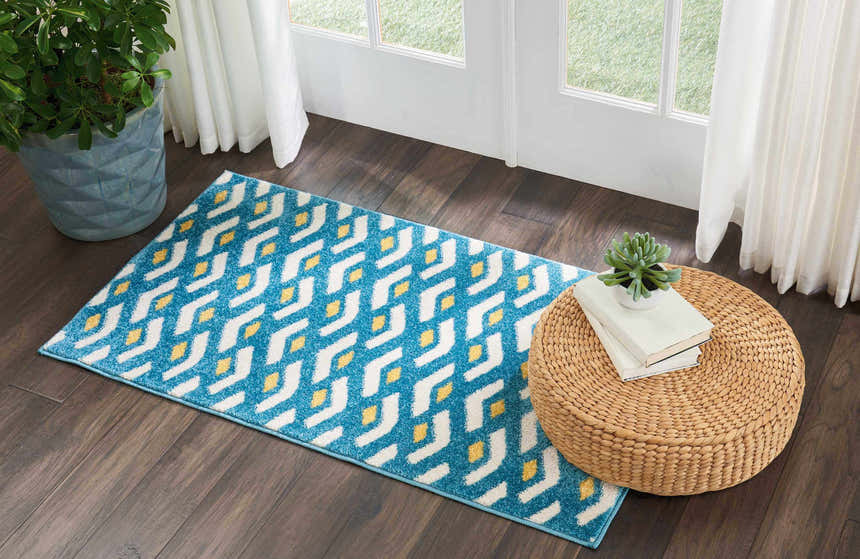 Entryway with Nourison Harper Blue Colorful runner rug, wood floors, wicker ottoman, and natural light.