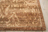 Close-up of a brown Nourison Silken Allure Persian rug. Handmade wool rug with a traditional pattern and soft texture.