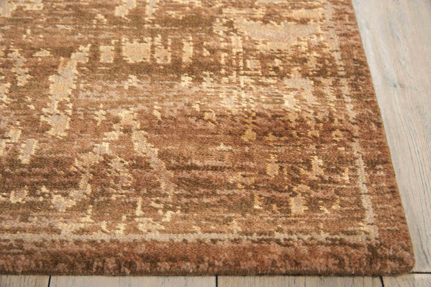 Close-up of a brown Nourison Silken Allure Persian rug. Handmade wool rug with a traditional pattern and soft texture.