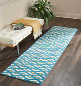 Entryway with Nourison Harper Blue runner rug, white bench, and dark wood floors.
