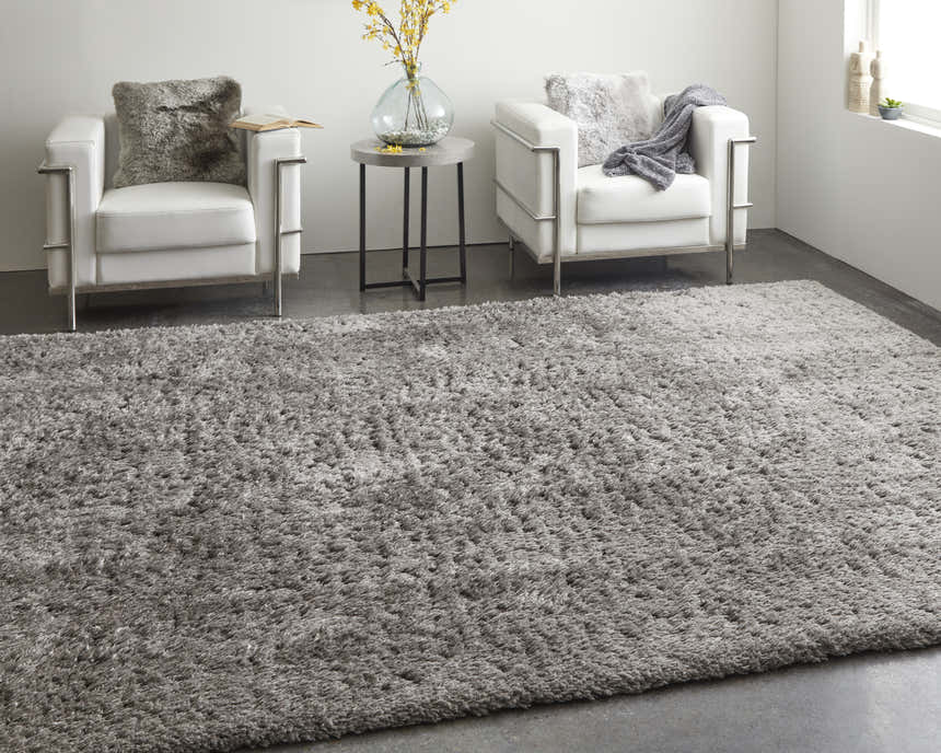 Modern living room scene with a gray Feizy Darian rug, white chairs, and a round side table. Roomscene-Rectangle