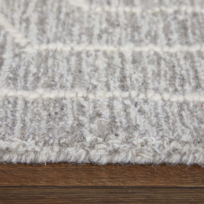 Close up of the Feizy Emerson rug showing gray and ivory wool texture and hand tufted construction. Pile