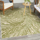 Outdoor patio scene with the Nourison Aloha Ivory Green area rug, wood furniture, and a small side table.