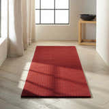 Minimalist room with a Calvin Klein Las Vegas Red Retro rug on light wood floors, near a window with linen curtains.