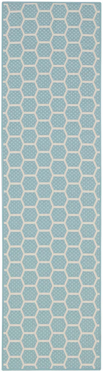 Close-up of Nourison Twist Reversible Aqua rug. Modern design with geometric honeycomb pattern in aqua and white.