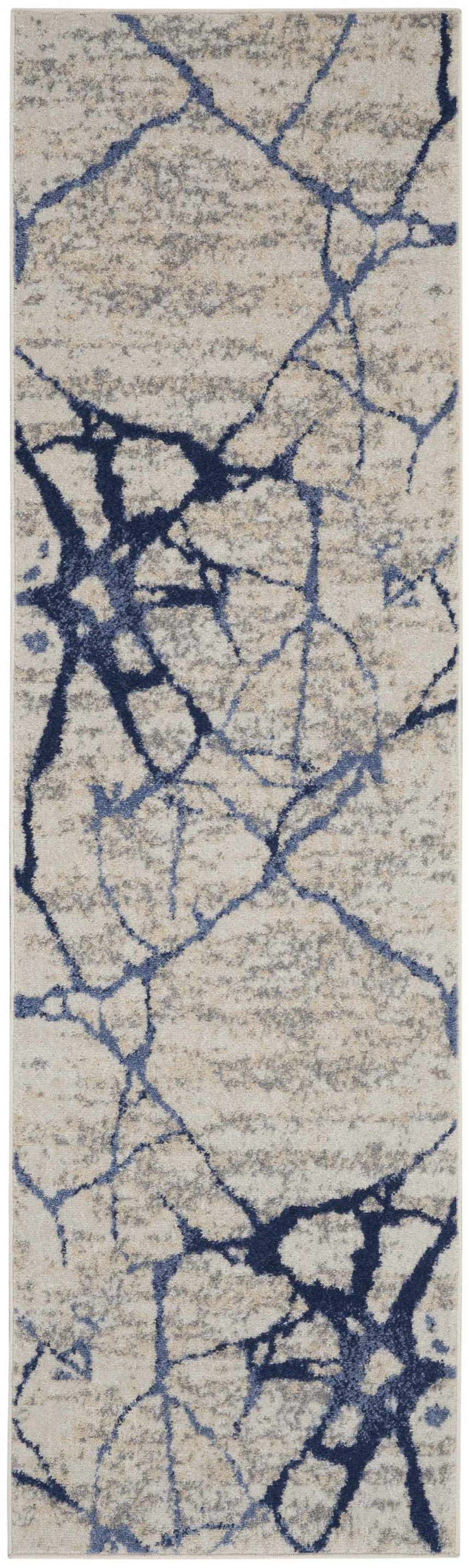 Close-up of Calvin Klein River Flow rug; ivory, blue abstract pattern. Modern, machine-made polypropylene rug.