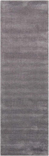 Close-up of the Calvin Klein Home Ravine Nightshade rug, featuring a subtle horizontal pattern and soft, rayon texture.