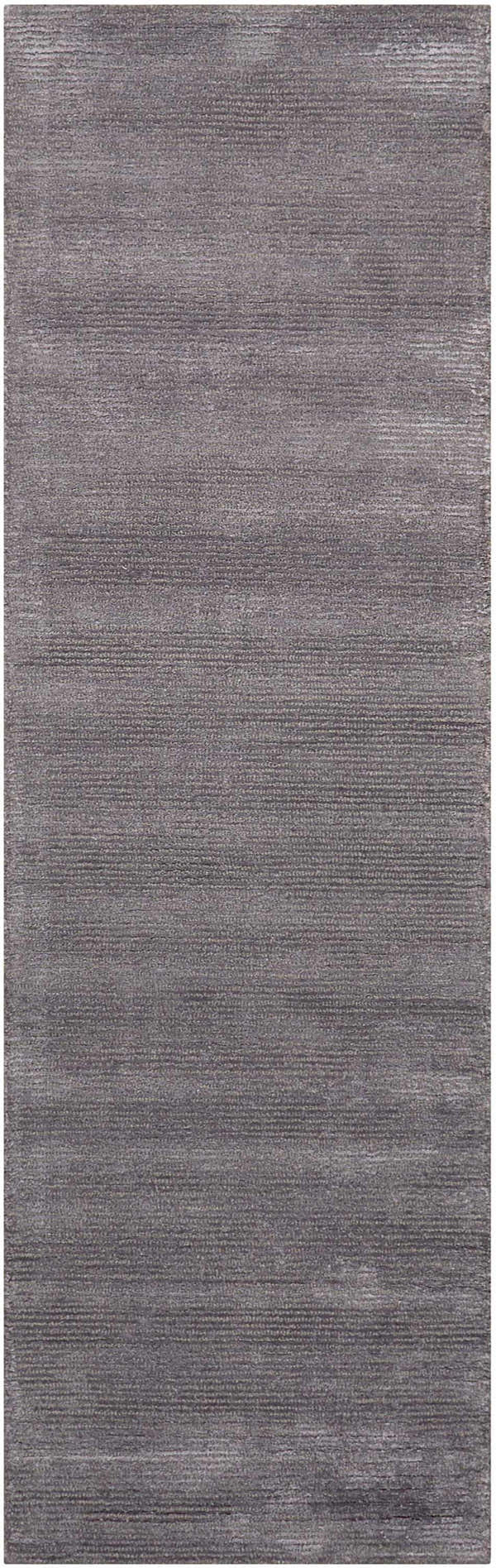 Close-up of the Calvin Klein Home Ravine Nightshade rug, featuring a subtle horizontal pattern and soft, rayon texture.
