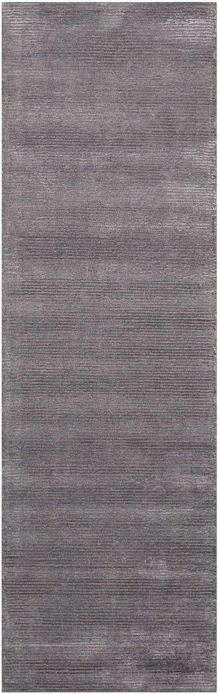 Close-up of the Calvin Klein Home Ravine Nightshade rug, featuring a subtle horizontal pattern and soft, rayon texture.