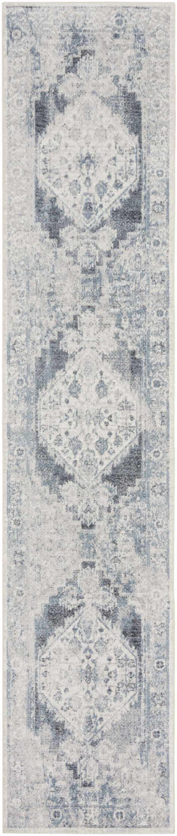 Close-up of Nourison Astra Blue Ivory rug. Vintage design with geometric patterns and distressed texture.