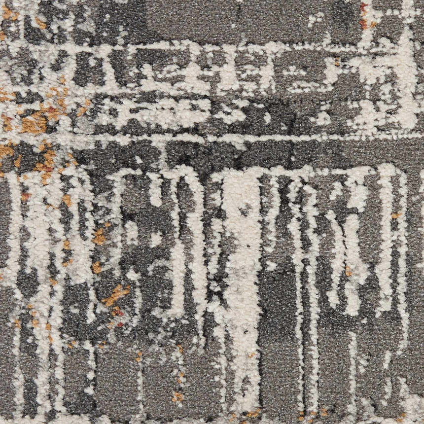 Close up of the multicolor Nourison Tangra rug showing gray, white, and gold abstract pattern.