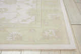 Close up of the ivory and green Nourison Zephyr rug showing floral pattern and wool texture.