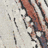 Close-up of Nourison Motion Ivory Multicolor rug showing the low pile texture and chestnut, black, and ivory hues.