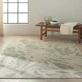 Minimalist room with Calvin Klein Home Maya Zinc/Paloma rug, wood bench, pitcher, and neutral decor.