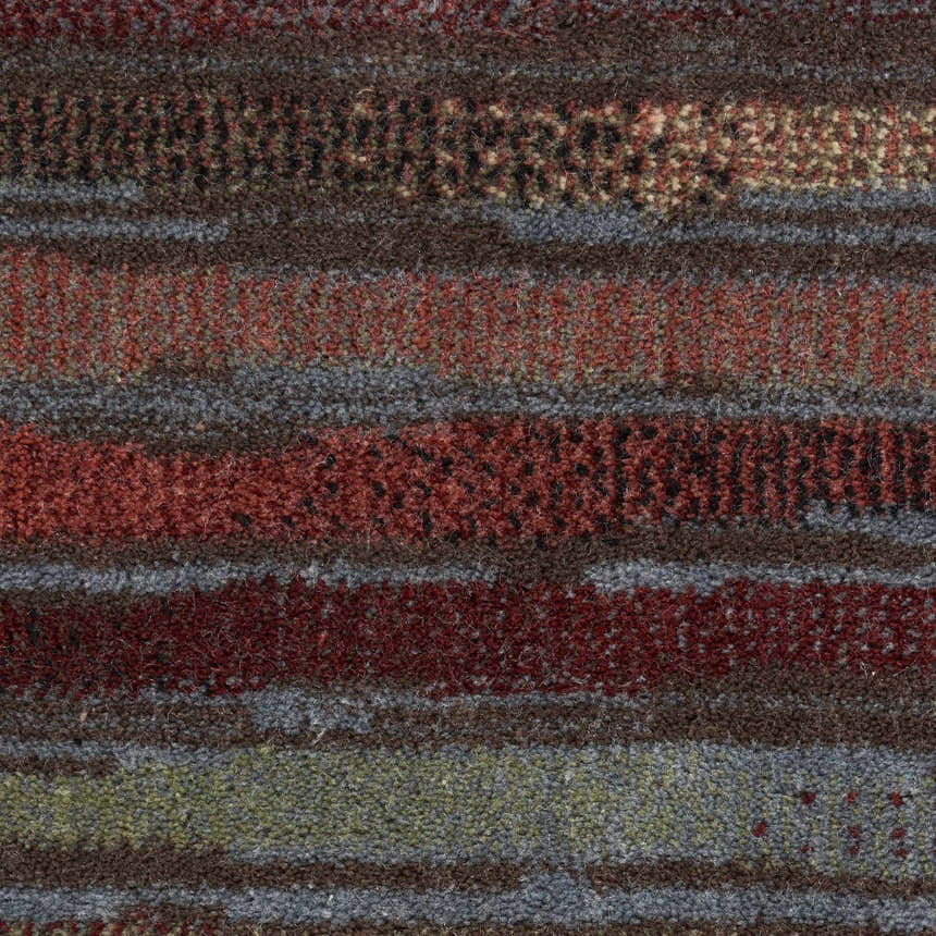 Close-up of the multicolor Nourison Expressions Painterly Area Rug, featuring textured stripes in red, brown, gray, and green.